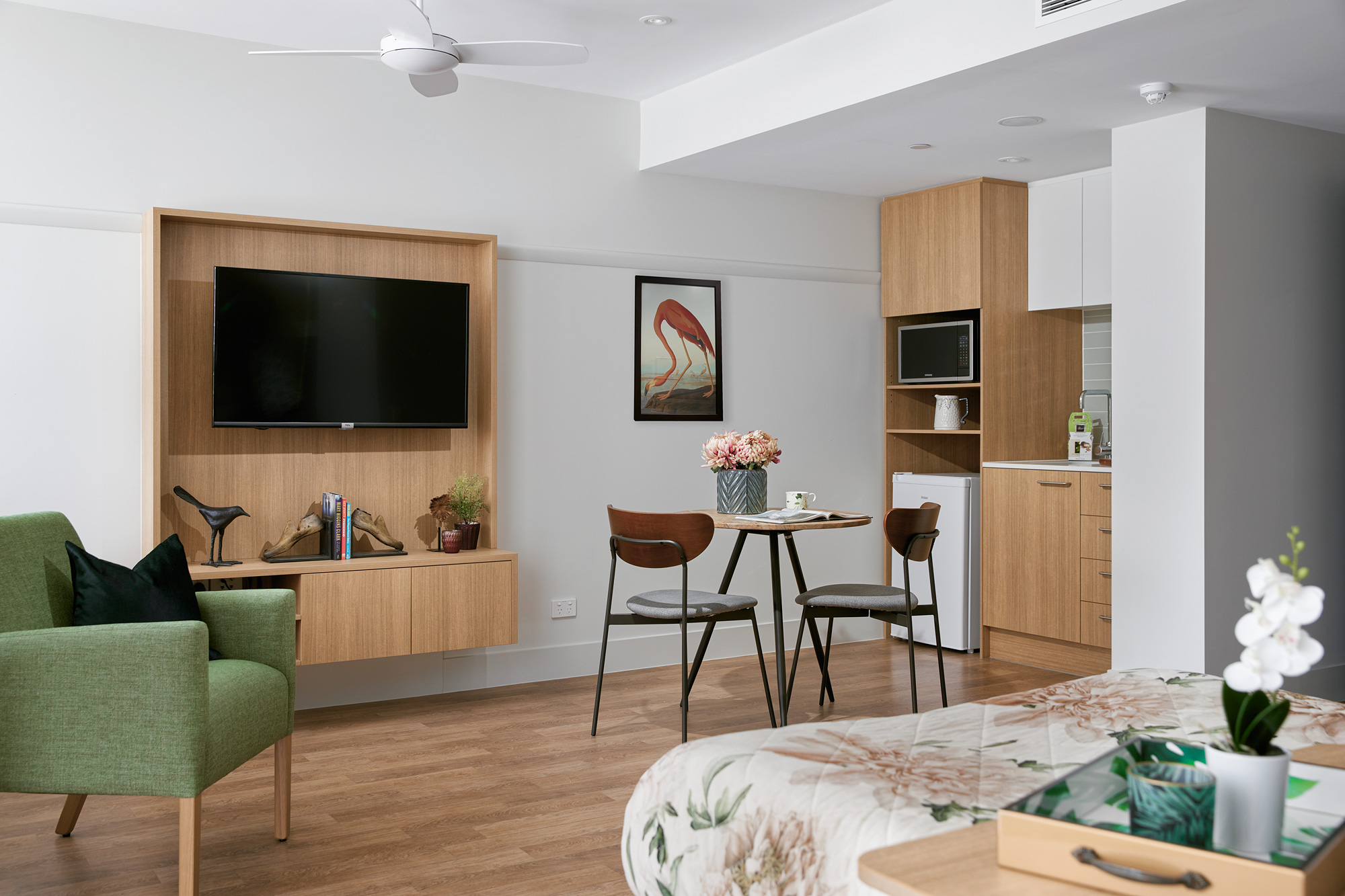 A luxurious Premium Suite at Strathpine Aged Care, featuring a private kitchenette, sitting area, and a spacious, light-filled layout.